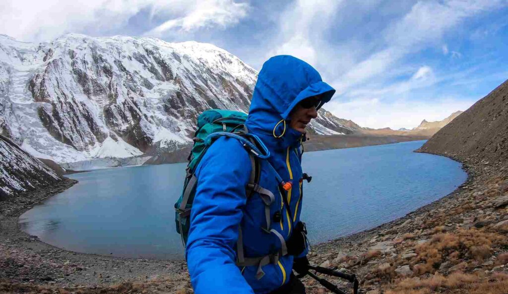 A man taking a sefie at the shore of Tilicho lake in Himalayas